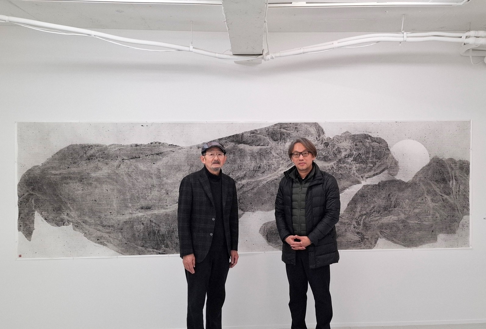 台灣日本藝術家交流展:《日本東京八壁展》:日本NAU21運營委員會委員長高橋俊明先生、台灣參展者 王穆提合影於台灣藝術家 王穆提作品前。